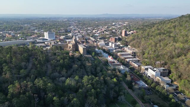 Aerial view of downtown asheville surrounded by forested hills.