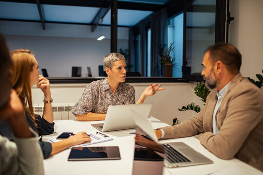Business team discussing strategy in modern office meeting room