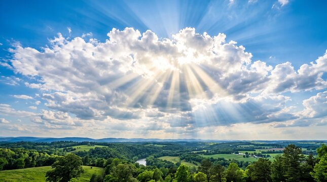 Sunbeams pierce through clouds over lush green rolling hills and a winding river