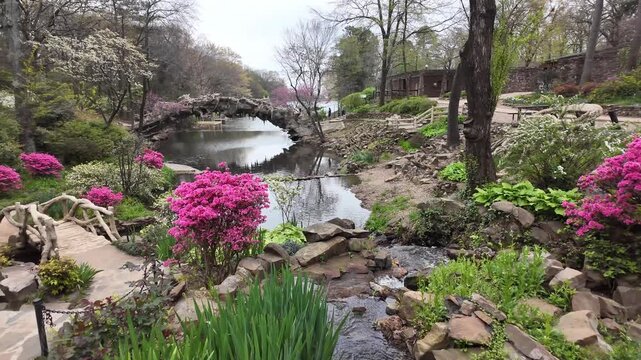 Stone mill and garden with pink flowers.