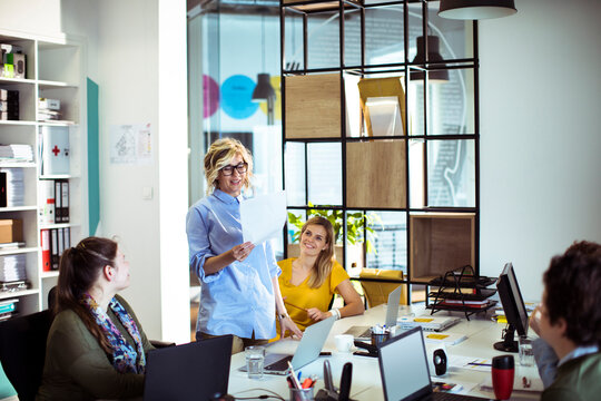 Coworkers collaborating during team meeting in modern office