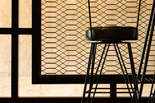 classic sitting chair with black metal pattern frame in the retro cafe