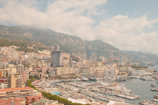 Aerial view of Port Hercule with luxury yachts and Monte Carlo skyline in Monaco