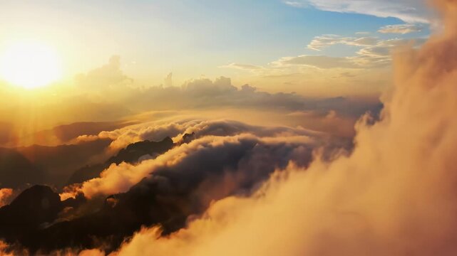 Aerial View of Sunrise Over Cloud Sea and Mountain Peaks at Golden Hour