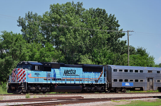 A westbound Metra commuter train, outbound from Chicago on its way through a northwestern suburban community destined for Elgin, Illinois. 
