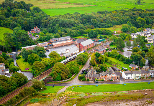 Passenger Train Passing Ravenglass at Low Tide on the Cumbrian Coast England