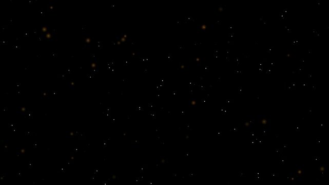 Floating particles of golden dust drifting slowly against a dark black background in wide panoramic view with dark space with motion