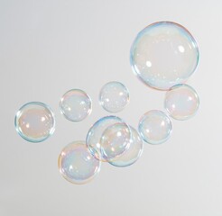 Obraz premium Colorful soap bubbles floating against white background