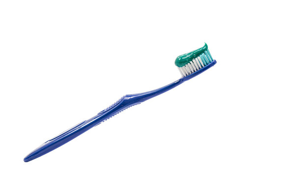 Blue toothbrush with green toothpaste swirl solated on transparent background
