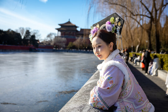 Asian woman wearing Qing dynasty traditional Chinese costume at Forbidden City in Beijing, China