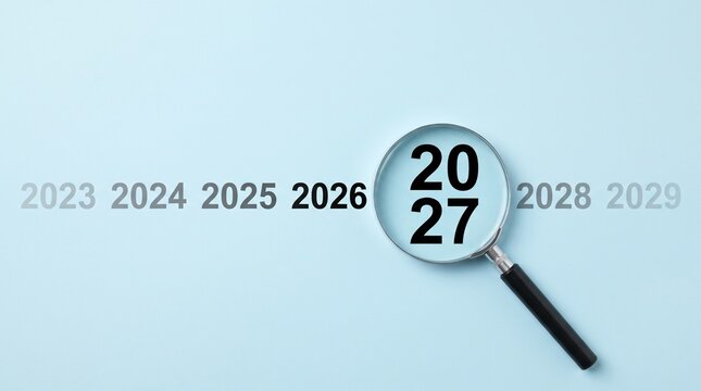 Looking into the future concept with magnifying glass focusing on year 2027