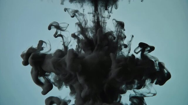 Captivating abstract vision of deep black ink dissolving gracefully in water, forming intricate smoky textures and an atmospheric spectacle of liquid movement