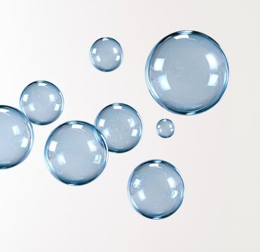 translucent blue bubbles floating on white background