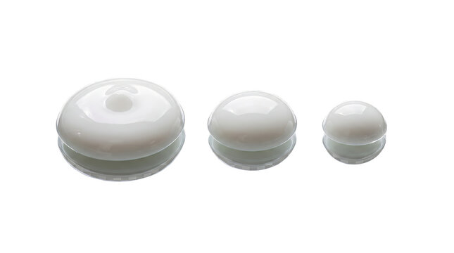 Skincare cream samples in three varying sizes are placed on a bright transparent surface.