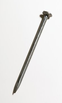 Closeup of rusty metal nail isolated on white