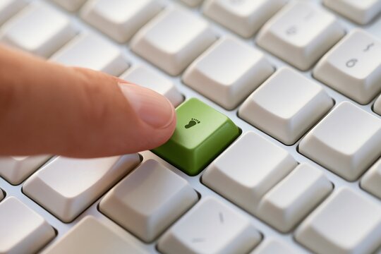 Human finger pressing green foot icon key on