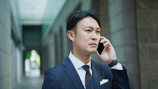 Businessman listening with a serious face during a phone call