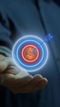 Businessman open hand vertical shot supporting glowing target bullseye with dollar coin. Financial profit goal achievement, investment revenue targeting, and wealth return strategy idea concept.