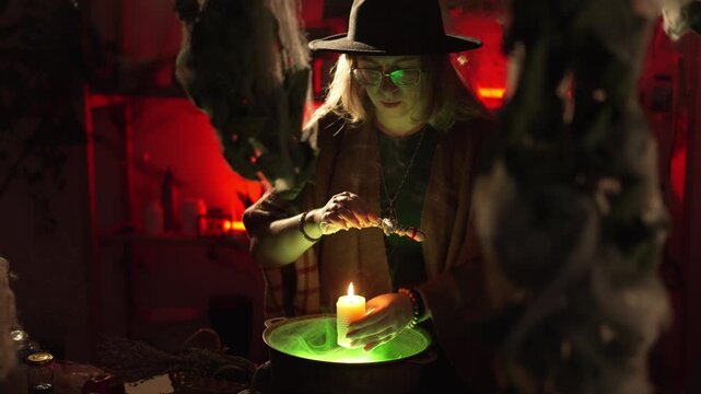 A realistic witch brewing a potion. She waves a voodoo doll over a burning candle and chants a spell. Everyday life intertwined with traditional witchcraft. Magic and a mystical atmosphere.