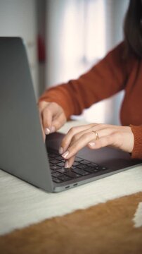 Close-up video of an anonymous woman&rsquo;s hands using a laptop in an office, highlighting professional work, technology, and digital productivity.
