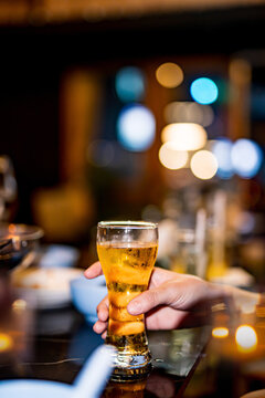 food and drink male friends are happy drinking beer and clinking glasses at a bar or pub.