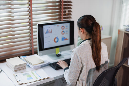 Woman working on computer analyzing business data report