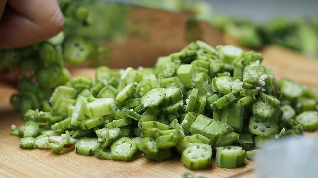 Preparing and slicing fresh okra for a delicious meal in the kitchen