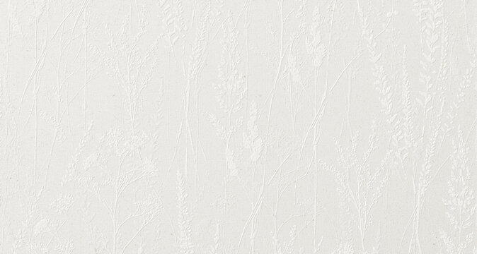 textured paper background featuring an elegant, embossed botanical pattern of wild meadow grasses and flowers.
