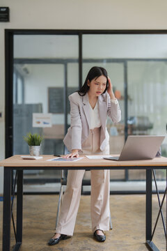 Stressed businesswoman experiencing workplace burnout and headache