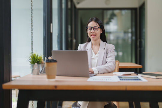 Professional businesswoman working on laptop in modern office