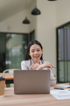 Asian businesswoman working online using laptop in office