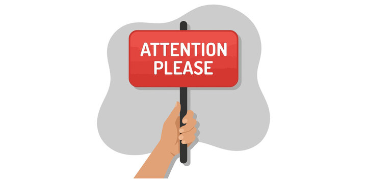 Red attention please sign held by hand for important announcements and urgent notification displays.