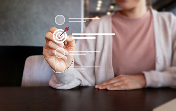 Woman using a digital target interface for goal setting, business planning, strategy, achievement and performance management in a modern workplace.