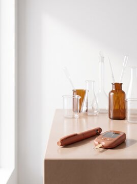 Modern Blood Glucose Meter and Insulin Pen on Laboratory Table with Glassware, Diabetes Management Concept, Medical Equipment for Diabetes Testing and Monitoring, Minimalist Healthcare Background