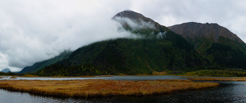 Alaska autumn landscape at Tern Lake with clouds over Wrong Mountain and Right Mountain in the town of Moose Pass at the crossroad of Seward and Sterling Highways