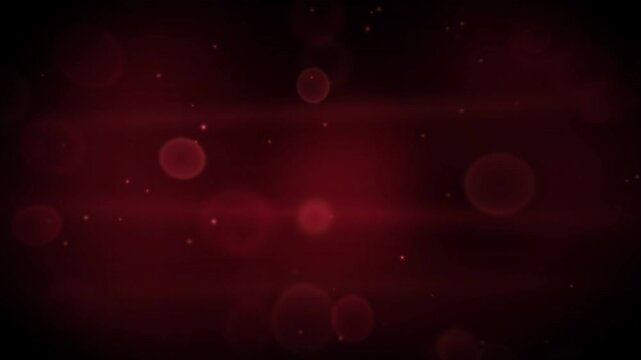 Abstract red background featuring soft glowing bokeh circles and fine floating particles in darkness.
