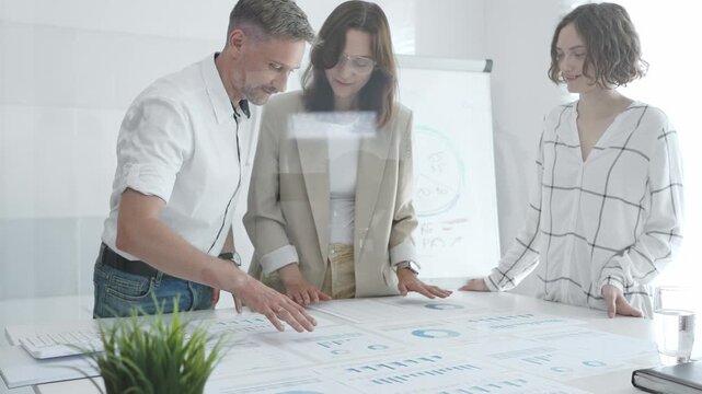 Business team collaborating and analyzing financial charts and graphs during a productive meeting in a modern office. Business people concept