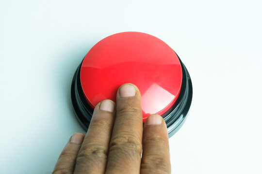 Hand finger pressing round big red button on white background, symbolizing emergency, control, and activation, perfect for concepts of safety, alert, and industrial equipment.