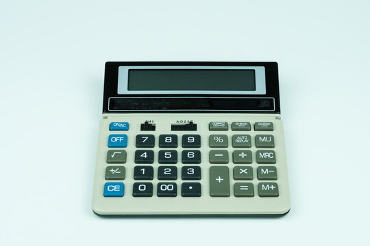 Calculator placed on white background with space for text placement, symbolizing finance, accounting, mathematics, calculation, and professional business tools.