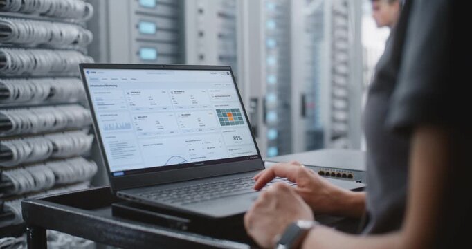 Female Data Center IT Engineer Responds to Critical Server Overheating Alert Through Linux CLI, Monitoring System Health and Entering Emergency Commands While Surrounded by Modern Server Racks.