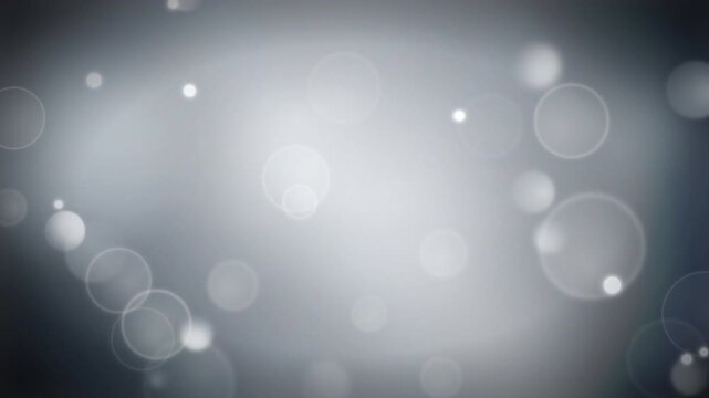 Blurred circular bokeh lights create a soft glowing effect on a dark gray gradient background.