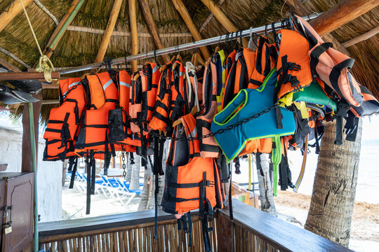 Colorful Life Jackets Hanging at Tropical Beach, Water Safety Equipment for Swimming and Water Activities
