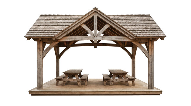 A rustic wooden gazebo structure featuring a shingled roof and timber frame construction, equipped with two picnic tables, isolated on transparent background