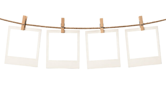 Four empty photo frames hanging on a rope isolated on transparent background