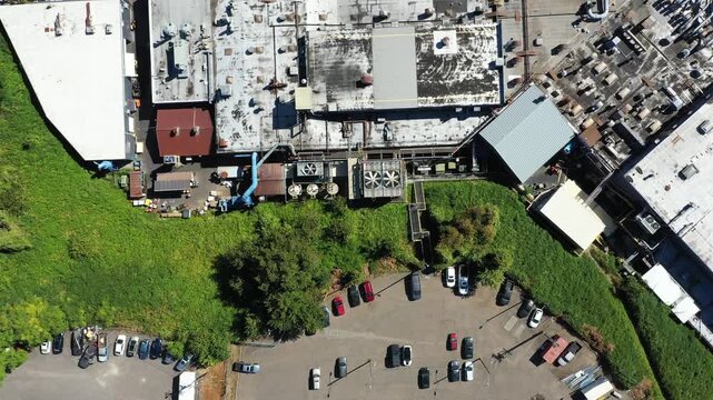 4K aerial drone footage of large aerospace metal manufacturing and casting factory in Portland, Oregon, USA, showing production buildings, machinery, pipes and industrial infrastructure