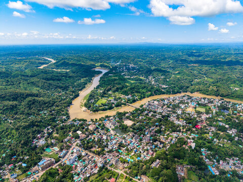 Wide Aerial Vista of Bandarban City surrounded by Sangu River and Lush Mountain Ranges. Bandarban is a remote and mountainous district in southeastern Bangladesh known for its lush green hills