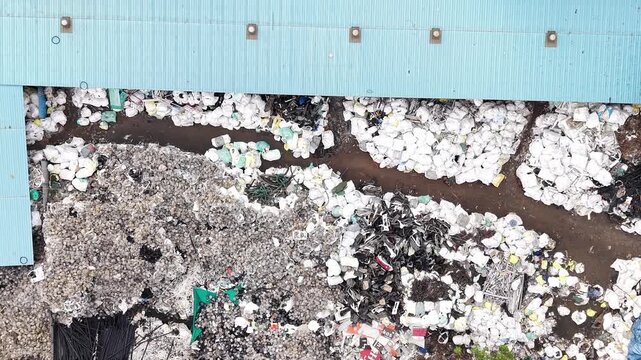 Mixed metal scrap under shed at scrap yard aerial scrap metal recycling industry salvage