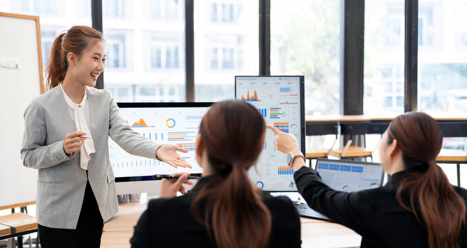 Asian Businesswoman Presenting Financial Data Report to Colleagues