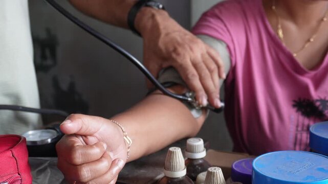 Measuring patient blood pressure with sphygmomanometer
