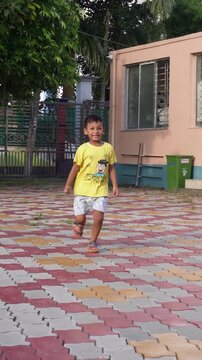Joyful child running outdoors in casual summer clothing
